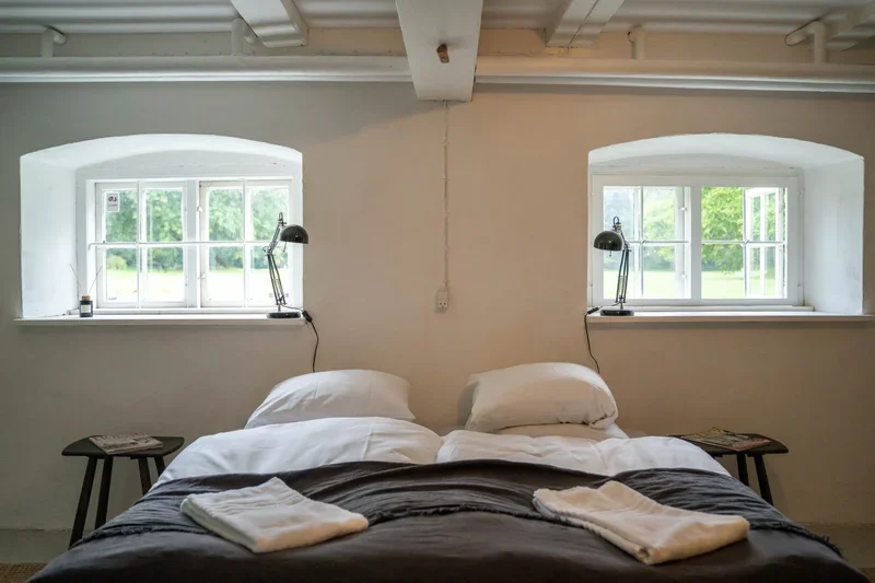 Soveværelse med buede vinduer og haveudsigt i herregården på Agerup Gods, Lolland